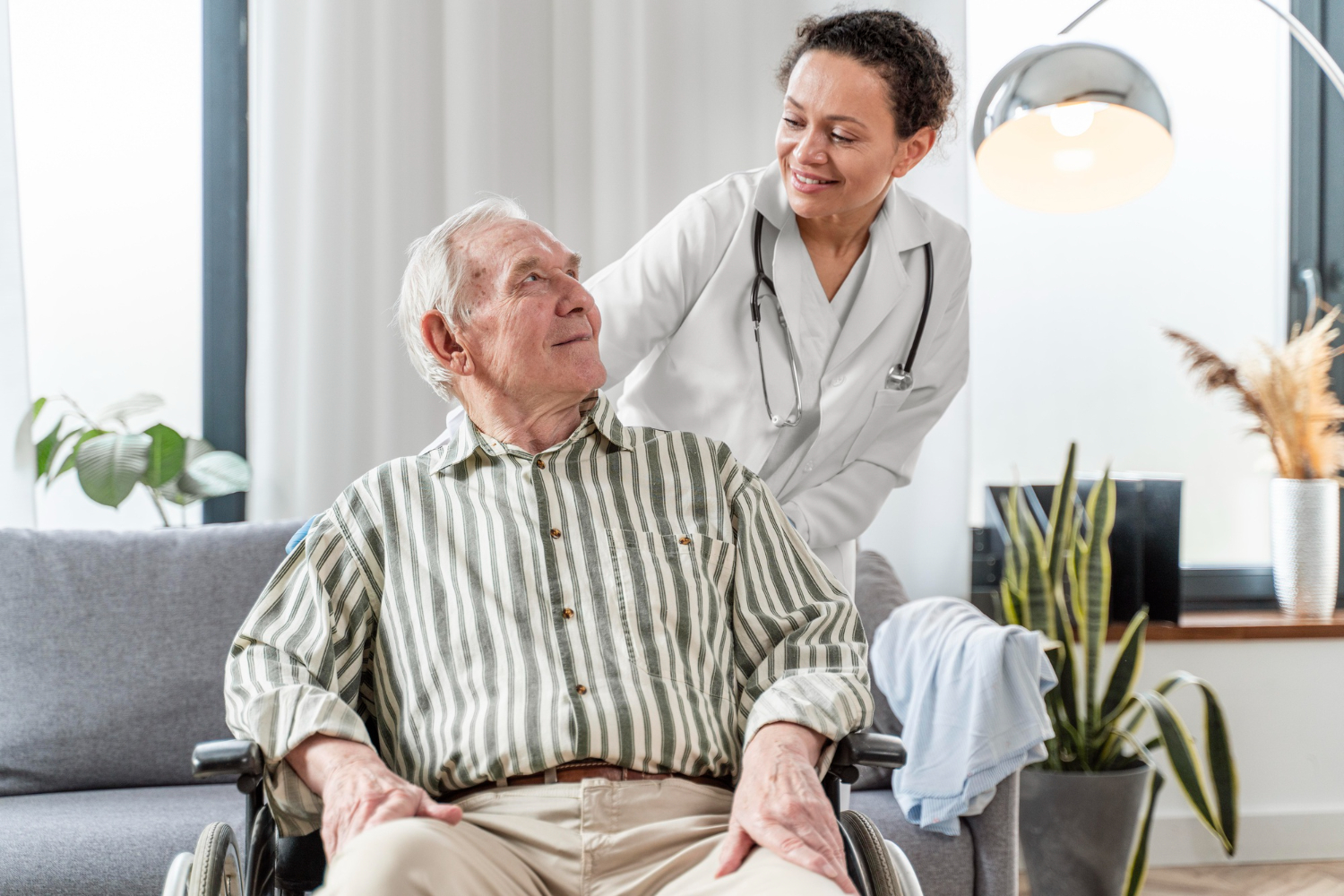 Smiling caregiver supporting a senior at home